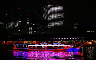 red and blue boat on lake during night time